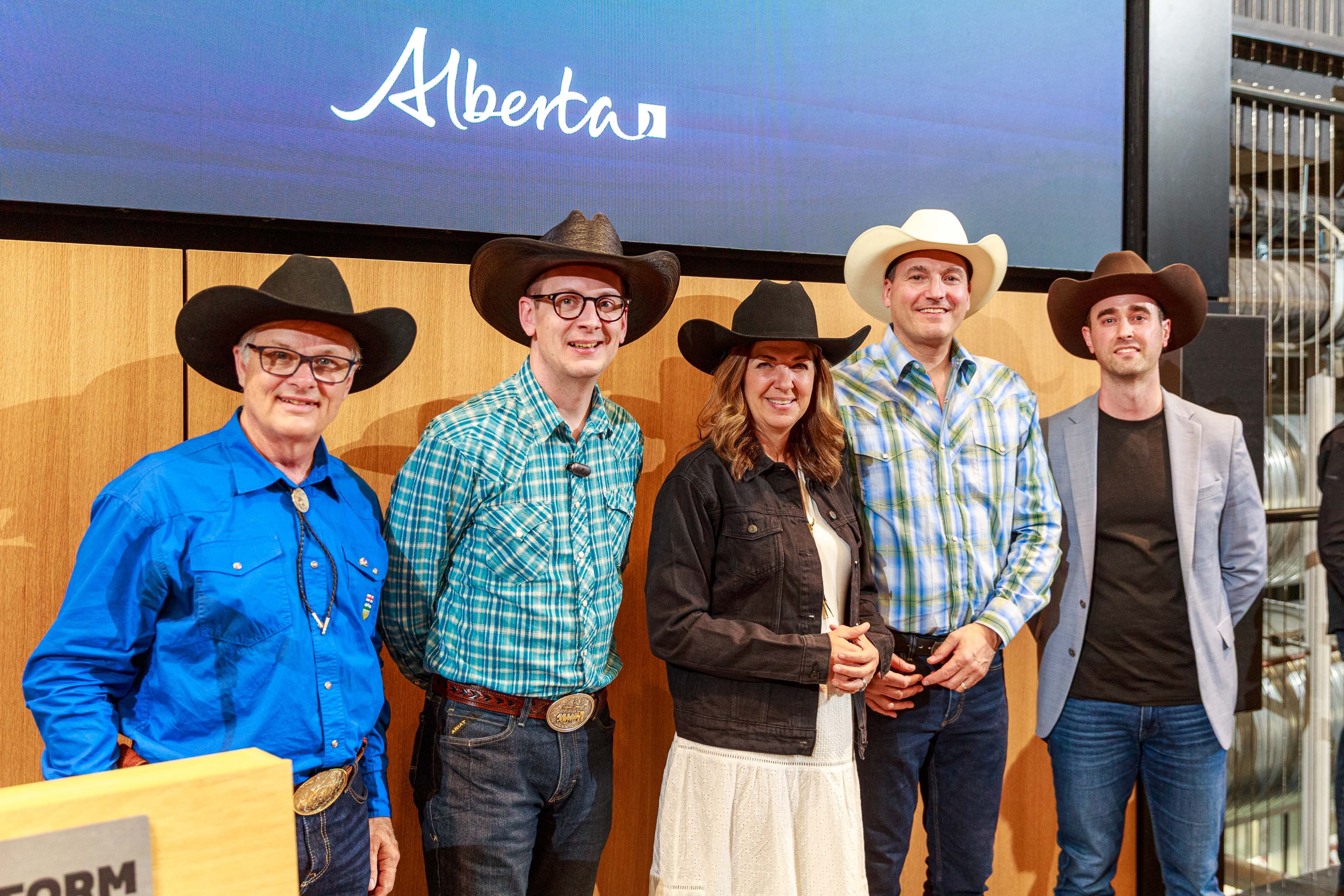 Posing for a photo at a recent funding announcement at the 2026 Calgary Stampede, from left: Myles McDougall, Nate Glubish, Danielle Smith, Evan Solomon, Cam Linke